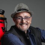 Edgardo Cambón beside a red conga drum