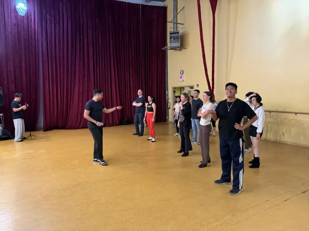 Salsa instructor addressing participants during the workshop